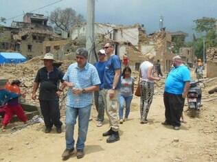 Sílvio (de camisa quadriculada) caminha entre escombros do primeiro terremoto; nova réplica atingiu fortemente a capital do Nepal, Katmandu, nesta terça-feira (12)