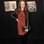 Estilosa, a modelo Coco Rocha escolheu vestido vermelho de onça e o combinou com legging, botas com franjas, clutch e jaqueta de couro, tudo preto. Foto: Getty Images