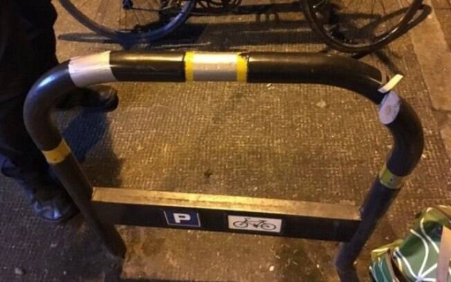O suporte (rack) público de bicicleta foi serrado e depois coberto com fita adesiva para esconder o corte