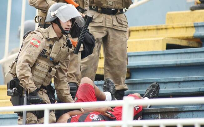Policiais militares se aproximam de torcedor do Atlético-PR que se envolveu em briga