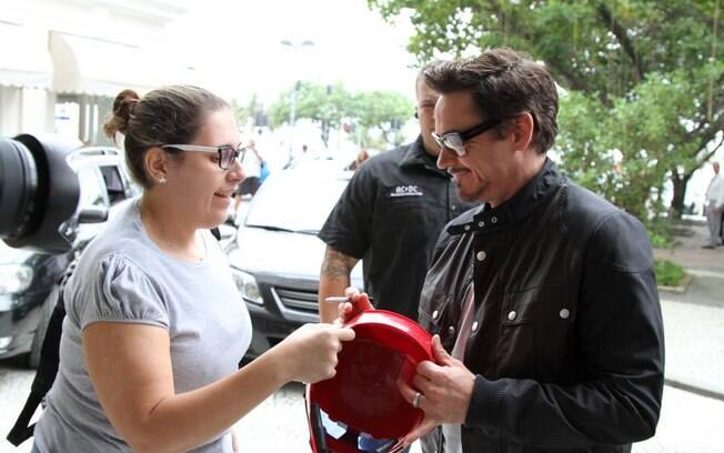Em sua visita ao Rio, Robert Downey Jr. assina o capacete do personagem Homem de Ferro para uma fã na porta do hotel