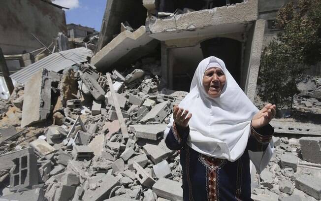 Palestina reage diante de destroços de sua casa, que a polícia diz ter sido destruída em ataque aéreo israelense em Rafah, sul da Faixa de Gaza (14/7)