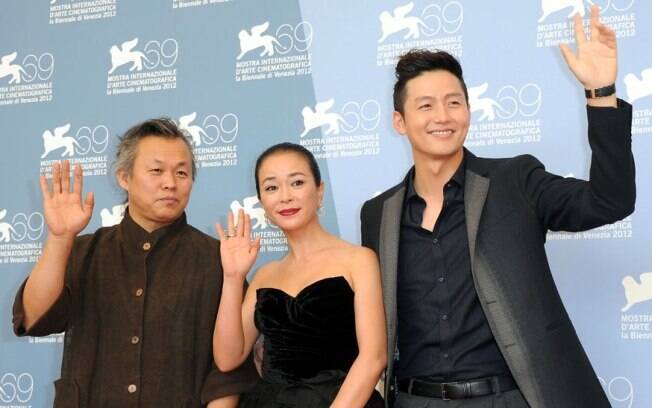 O diretor Kim Ki-duk, a atriz Cho Min-soo e o ator Lee Jung-jin acenam para fotógrafos no Festival de Veneza