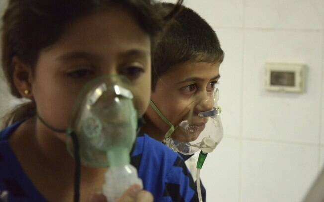 Crianças afetadas por suposto ataque químico respiram com máscaras de oxigênio no subúrbio de Saqba, Damasco
