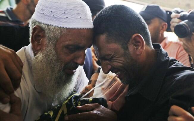 Parentes choram enquanto seguram corpo de Sarah Omar el-Eid, 4, que foi morta por ataque de Israel contra Gaza (15/7)