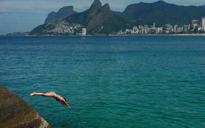 Banhista mergulha no mar na praia do Arpoador, na zona sul no Rio de Janeiro