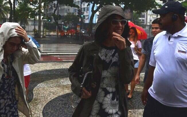Fernanda Torres autografa livro em quiosque na praia em dia de chuva