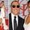 Bronzeadíssimo, o designer Michael Kors foi acompanhado da top estilosa Joan Smalls ao evento. Foto: Getty Images
