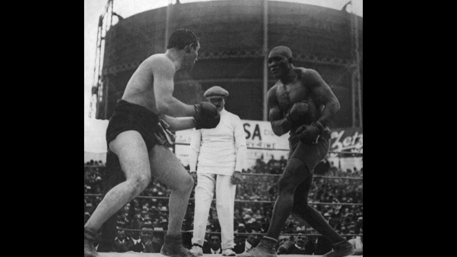 Johnson se torna campeão mundial pela primeira vez ao derrotar Tommy Burns (1908). Johnson se torna campeão mundial pela primeira vez ao derrotar Tommy Burns (1908).