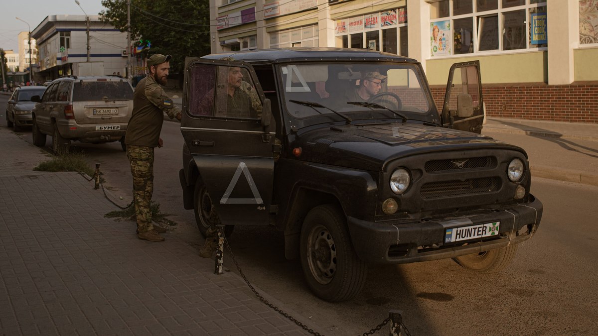 Unidade militar ucraniana de quatro homens pára a cidade para ir ao mercado em Sumy, a cidade situada a 30 km da fronteira russa que se tornou um centro militar durante a guerra Rússia-Ucrânia depois de a Ucrânia ter avançado para o interior do Kursk em 14 de setembro de 2024. 