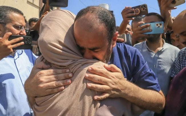O diretor do hospital Al Shifa de Gaza, Mohamed Abu Salmiya, abraça parente depois de ser liberado da prisão, em Khan Yunis, sul de Gaza