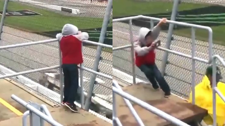 Vale tudo pela imagem: mini fã enfrenta vento para filmar corrida