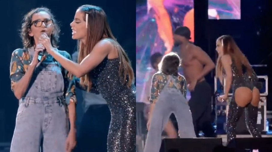 Anitta com fã em palco de show no festival 'Garota VIP'
