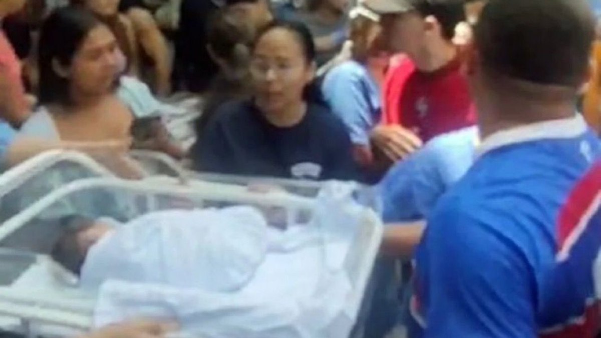 Funcionários e populares retiram bebês da unidade de saúde Funcionários e populares retiram bebês da unidade de saúde