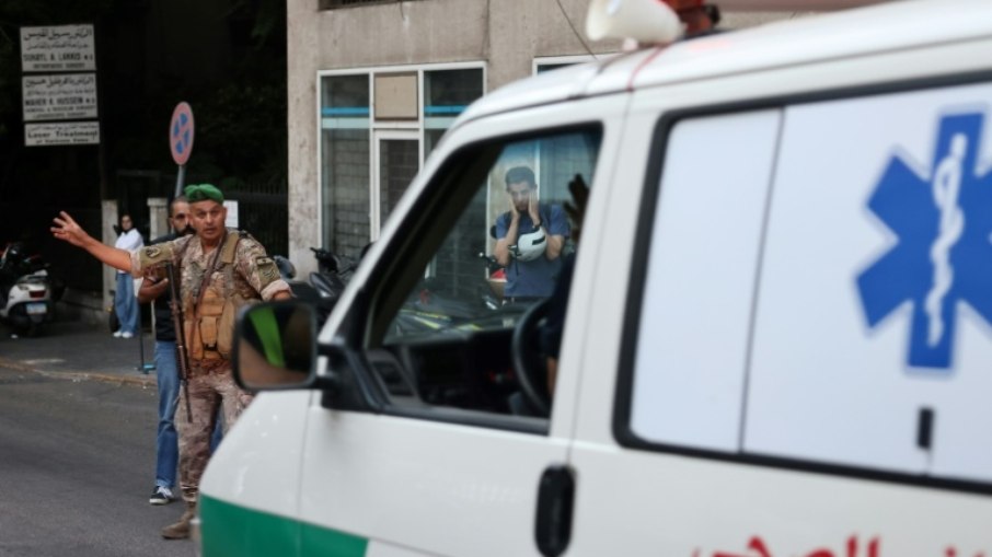 Um soldado do Exército libanês gesticula para uma ambulância que levava pessoas feridas para um hospital em Beirute, em 17 de setembro de 2024, depois que explosões atingiram vários redutos do Hezbollah ao redor do Líbano