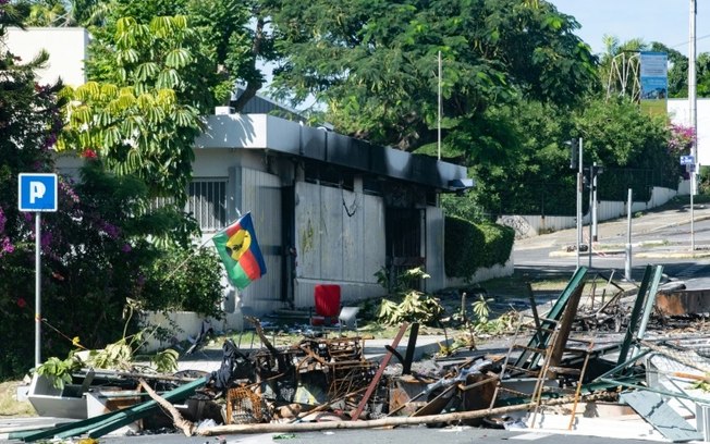 Uma casa incendiada em uma rua bloqueada por escombros no distrito de Magenta, em Nouméa, Território Francês do Pacífico, em 18 de maio de 2024 Uma casa incendiada em uma rua bloqueada por escombros no distrito de Magenta, em Nouméa, Território Francês do Pacífico, em 18 de maio de 2024