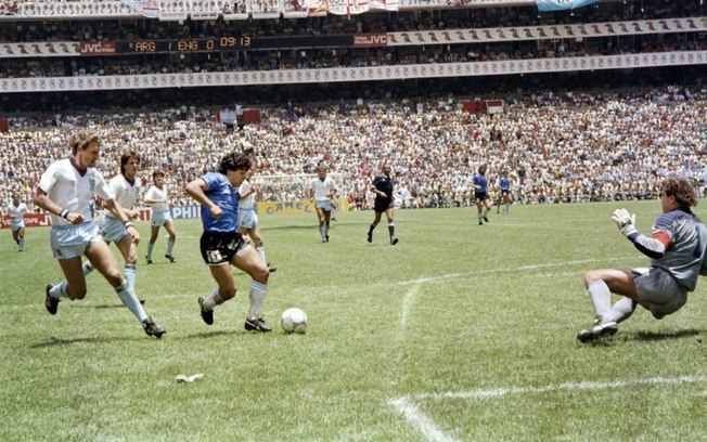 (arquivo) O craque argentino Diego Maradona passa pelo zagueiro inglês Terry Butcher (esq.) a caminho de driblar o goleiro Peter Shilton (dir.) e marcar seu segundo gol, pelas quartas de final da Copa do Mundo em 22 de junho de 1986, na Cidade do México.