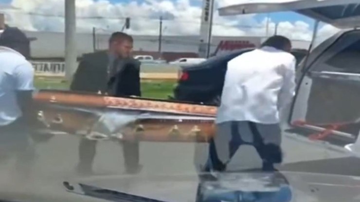 Caix%C3%A3o%20com%20corpo%20cai%20de%20carro%20funer%C3%A1rio%20em%20movimento