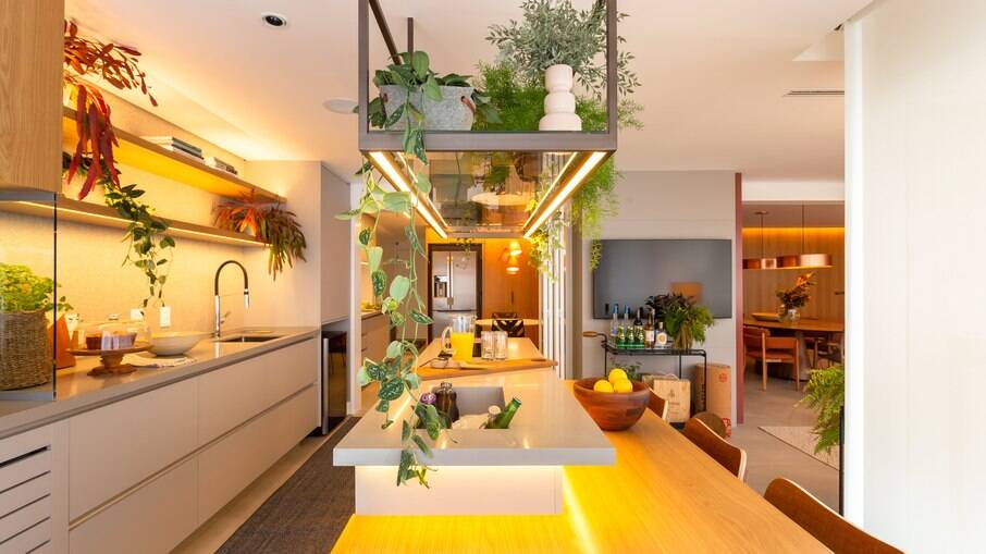 Nesta cozinha projetada pelas arquitetas Claudia Yamada e Monike Lafuente, responsáveis pelo Studio Tan-Gram, o LED ilumina as prateleiras e a pia