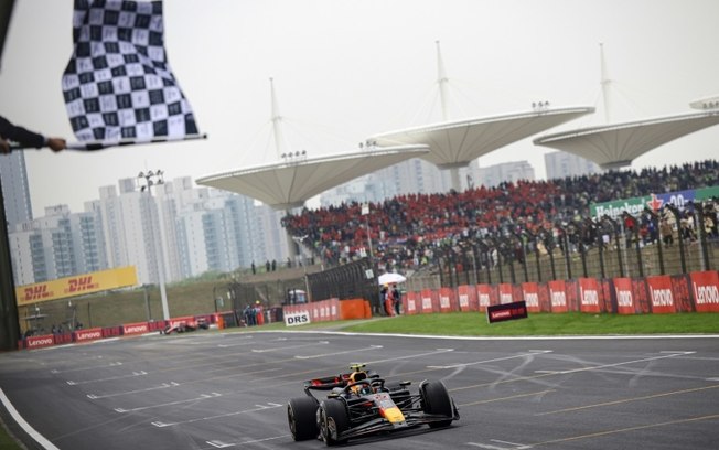 O piloto holandês Max Verstappen recebe a bandeira quadriculada ao vencer o Grande Prêmio da China