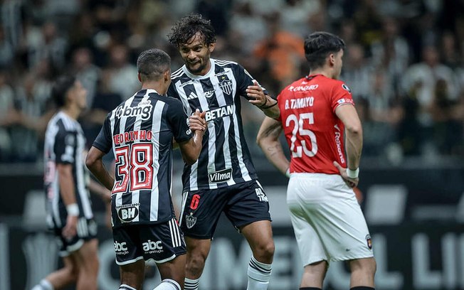 Scarpa celebra o gol de Pedrinho (de costas), o primeiro do Atlético sobre o Caracas