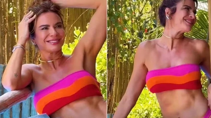 Luciana%20Gimenez%20posa%20de%20biqu%C3%ADni%20rosa%20e%20laranja%20ao%20sol