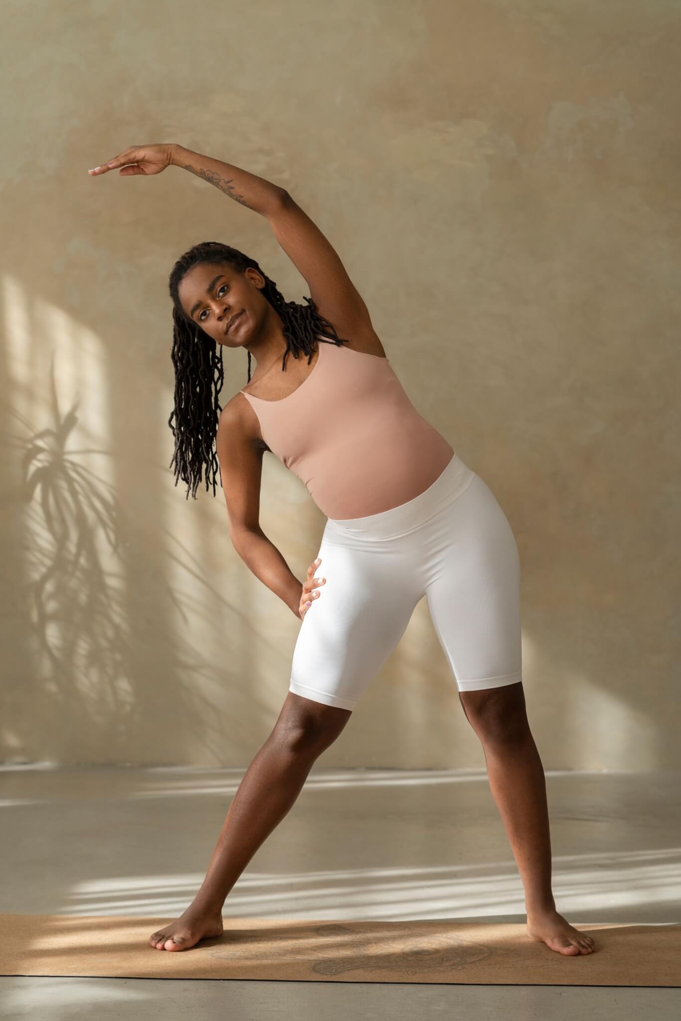 2. Faça yoga em pé Para o primeiro trimestre são aconselhadas posturas de yoga em pé, pois isso ajudará a fortalecer as pernas, melhorar a circulação e gerar energia, podendo reduzir cãibras nos membros inferiores. Reprodução: EdiCase
