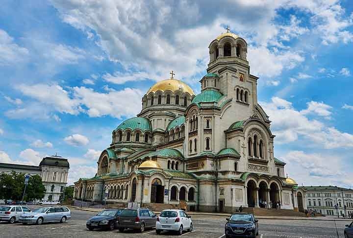 Catedral de Alexandre Nevsky - Sofia - Bulgária. Inaugurada em 1912, a catedral presta homenagem ao príncipe russo Alexandre Nevsky, um herói nacional da Rússia. Com sua impressionante fachada dourada e cúpulas verdes, ela se destaca como um dos maiores edifícios religiosos dos Balcãs. Reprodução: Flipar