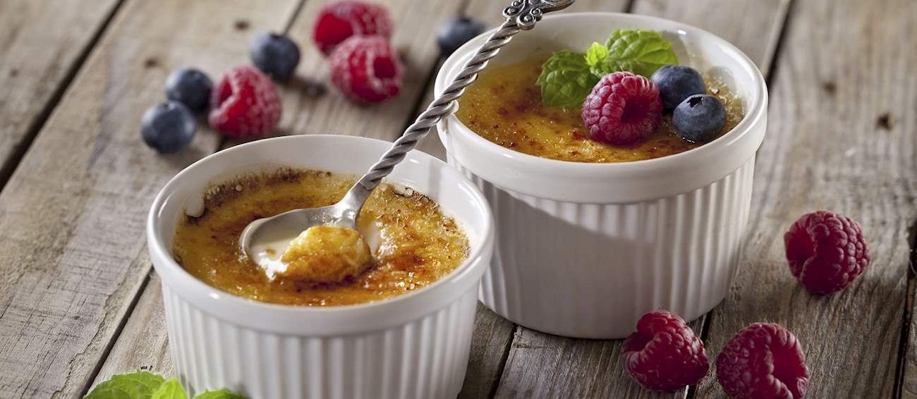 12º - Crème brûlée (França): Esta tradicional sobremesa de creme de ovo consiste em gemas, creme, açúcar e baunilha, com uma crosta dura e queimada de caramelo. A combinação é cozida, transferida para ramequins, escalfada em banho-maria e bem resfriada. O creme resfriado é normalmente colocado em pratos largos e planos e depois coberto com açúcar mascavo, que é caramelizado na grelha ou com maçarico. Reprodução: Flipar