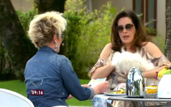 Para continuar a entrevista, Claudia teve que tirar o cachorro do colo de Ana Maria. Foto: Reprodução