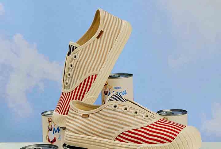 Anacapri e Nestlé - Com identidade visual Inspirada na lata de leite condensado Leite Moça, as empresas criaram a coleção “Adocica, meu amor!”, com uma variedade de produtos, como tênis, chinelos e bolsas. 
 Reprodução: Flipar