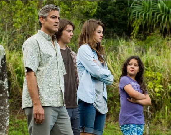 Os Descendentes (2012)
Dirigido por Alexander Payne, estrelado por George Clooney, Shailene Woodley e Amara Miller.
Um pai tenta se reconectar com as filhas após um acidente que deixou sua esposa em coma, enquanto enfrenta decisões sobre herança familiar no Havaí. Reprodução: Flipar