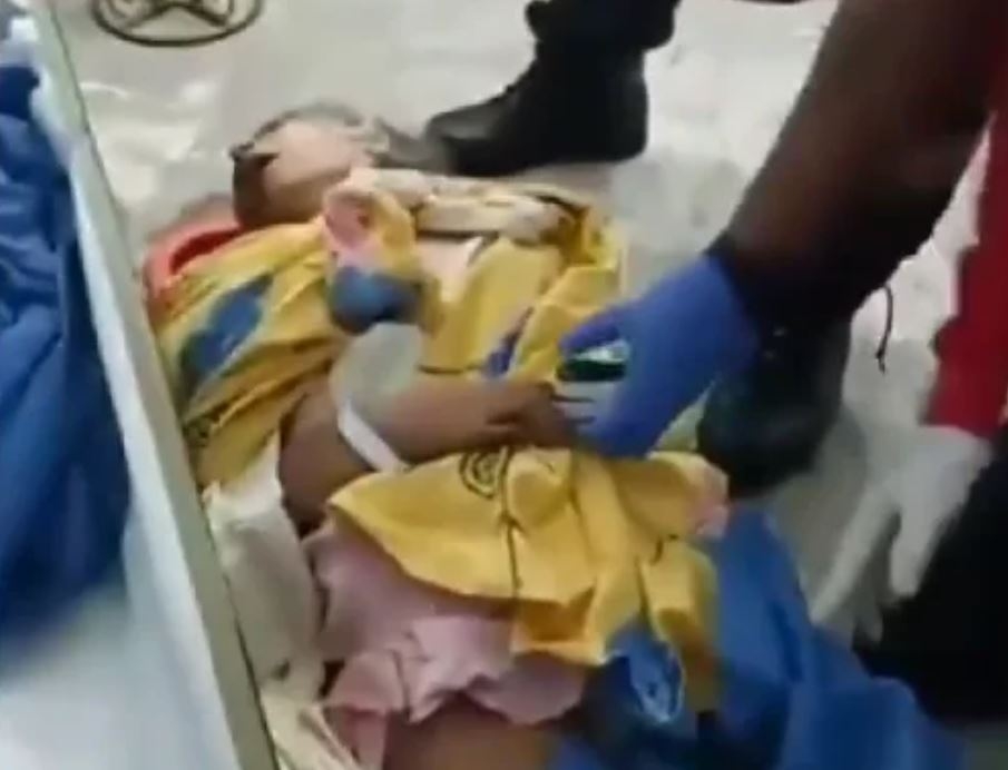 No Twitter, circulou vídeo que mostra a idosa dentro do caixão aberto fazendo aflitivo esforço para respirar. Nas imagens, duas pessoas acodem Bella Montoya enquanto ela se remexe no esquife Reprodução: Flipar